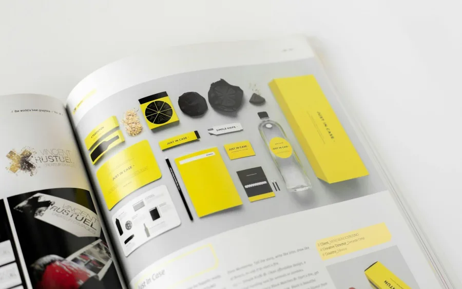 Printed brand guidelines book showing a complete brand identity system