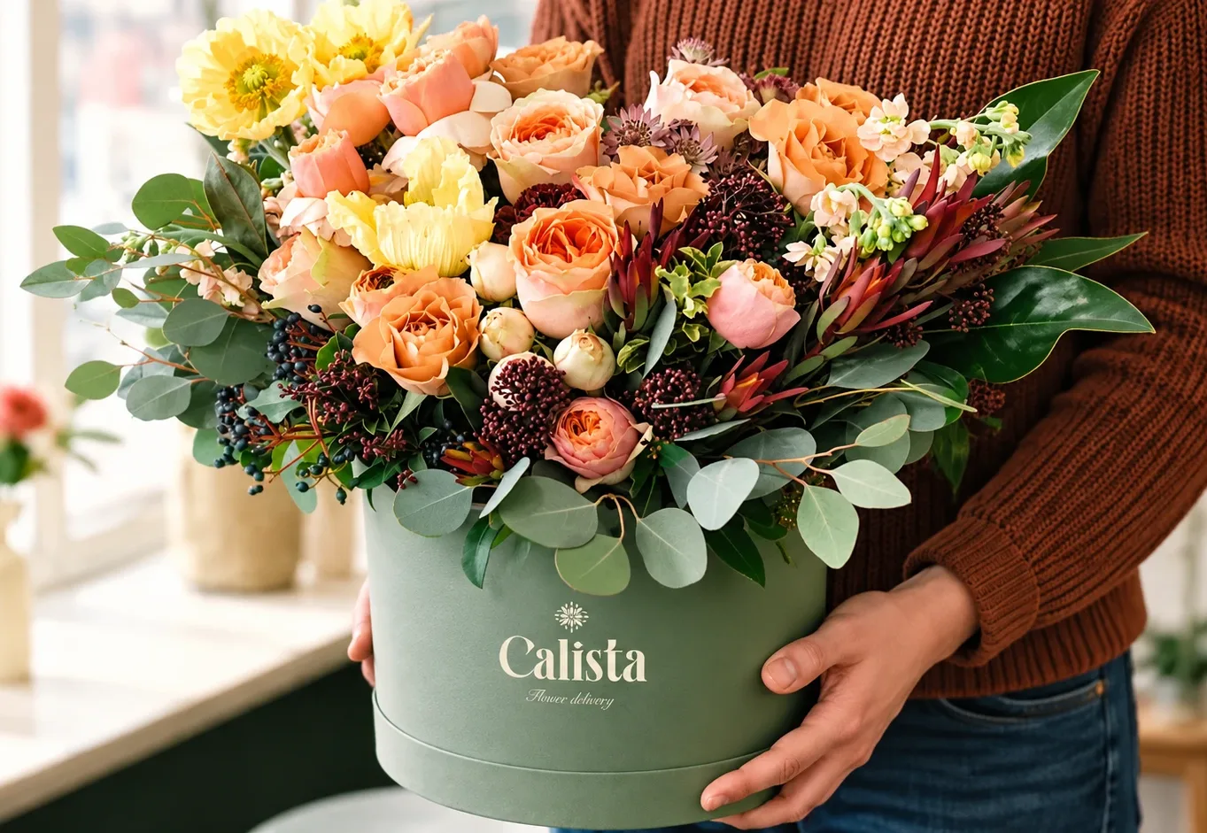 Calista: a bouquet in the sage hatbox carrying the Calista wordmark