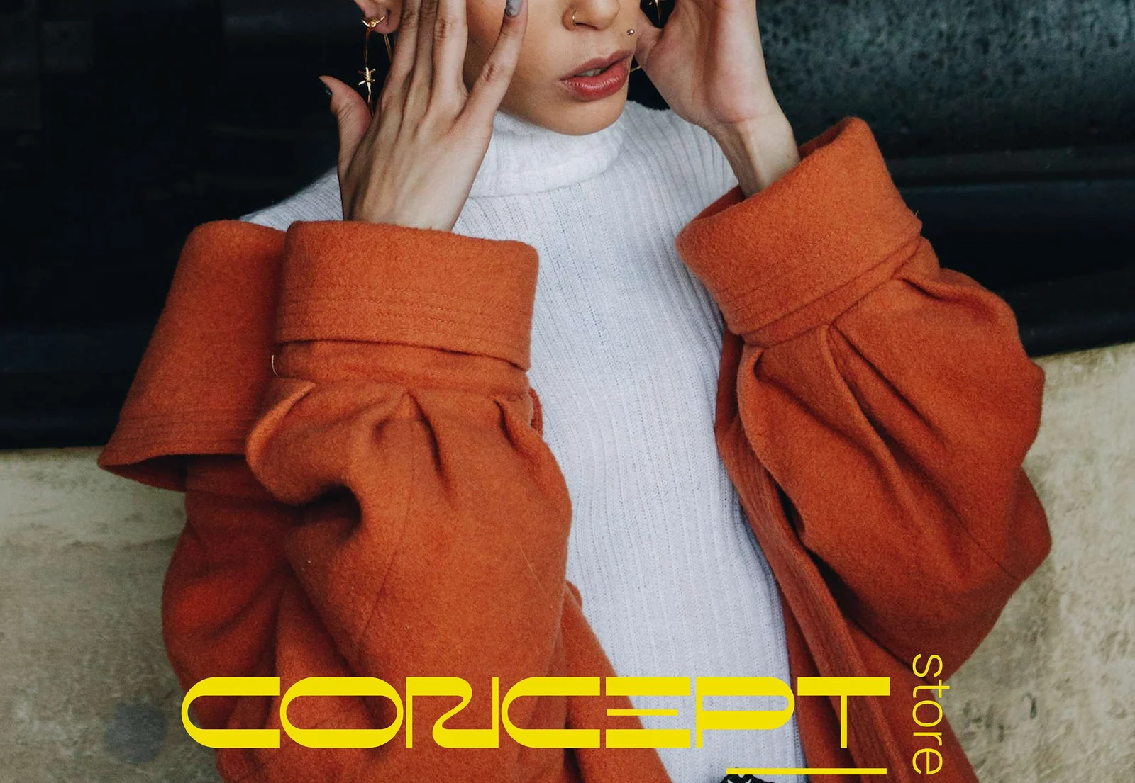 Concept Store: the wordmark over an orange wool coat