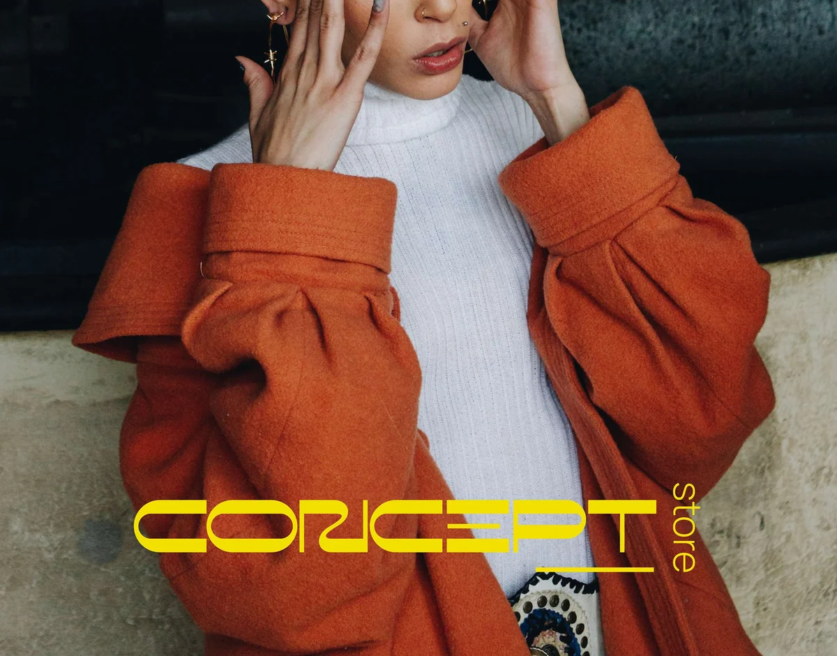 Concept Store: the wordmark over an orange wool coat