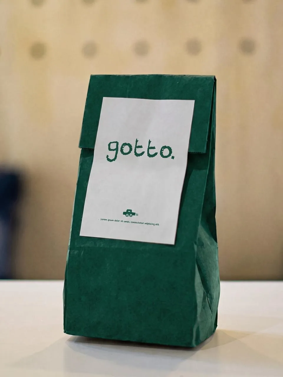 GOTTO: the gotto. label on a green paper takeaway bag