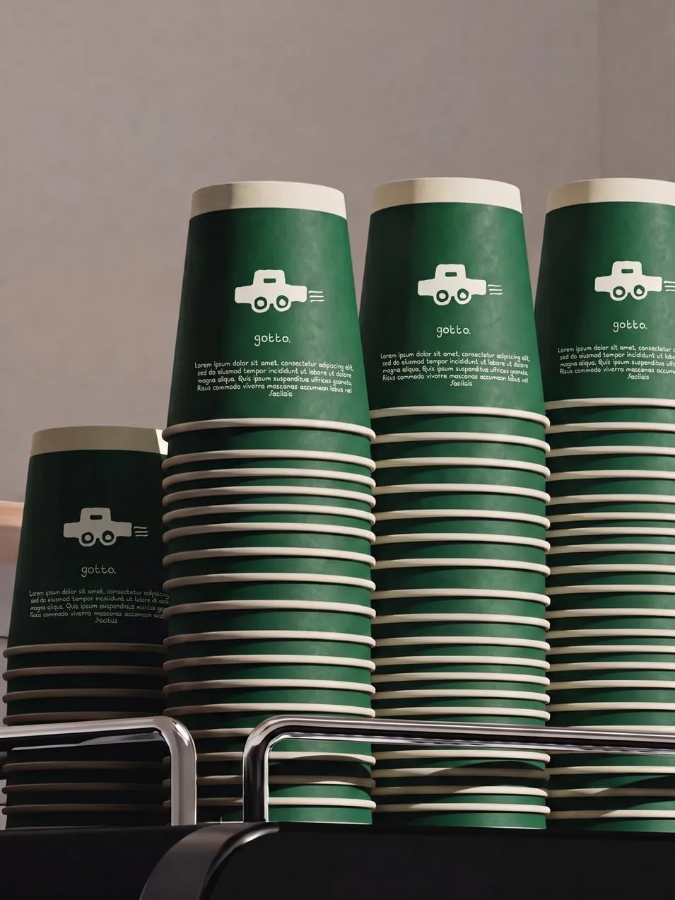 GOTTO: green takeaway cups stacked high, each printed with the toy car mark