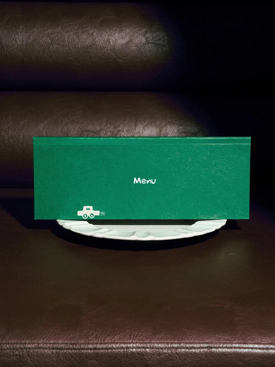 GOTTO: a green menu card signed with the toy car, standing on a plate