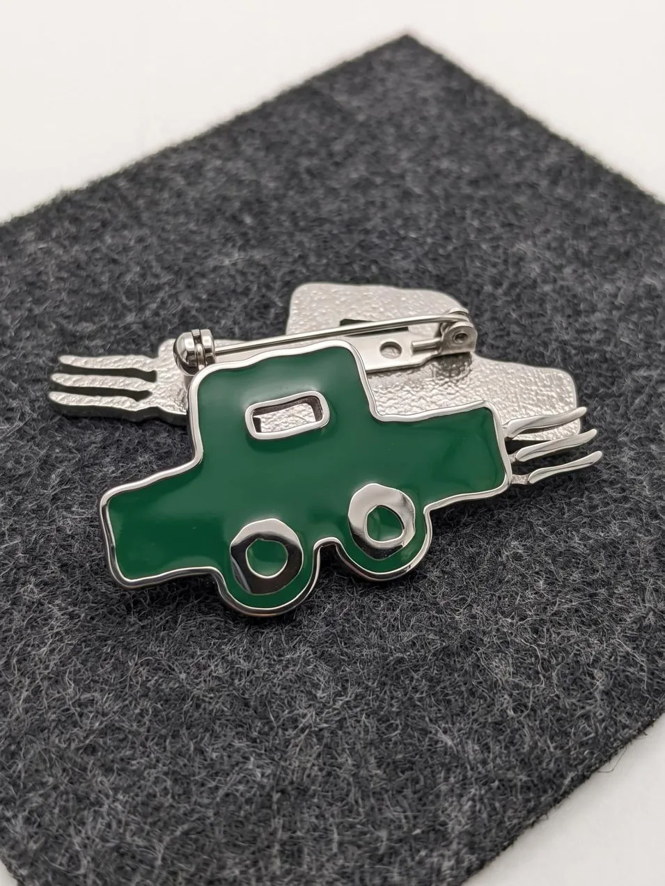 GOTTO: an enamel pin of the toy car in green and silver