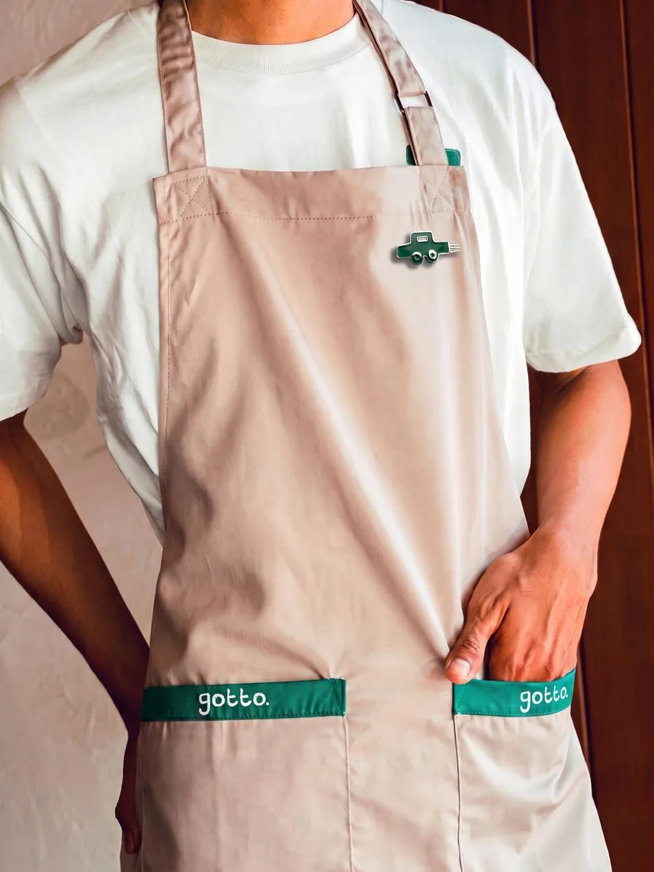 GOTTO: a cafe apron with gotto. on both pockets and a toy car pin