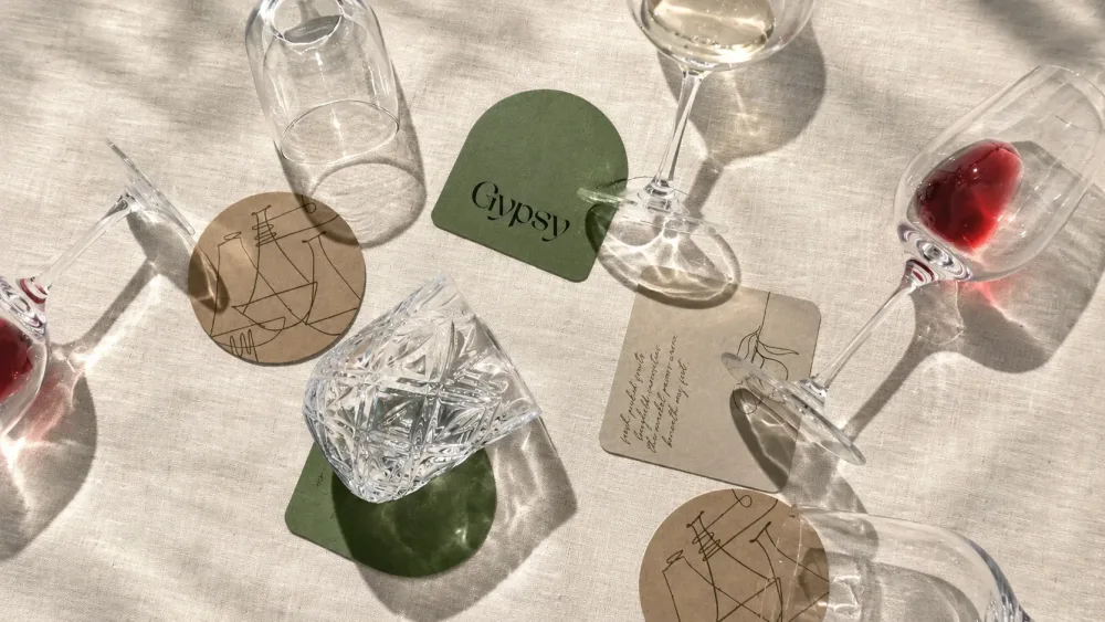 Gypsy: the coasters among wine glasses on a linen tablecloth