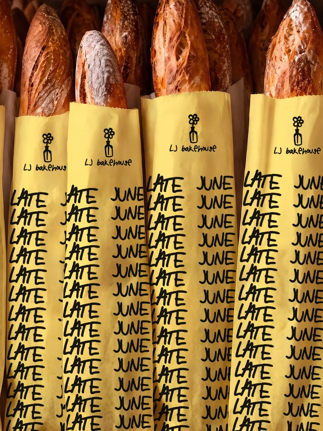 Late June Bakehouse: baguettes in yellow sleeves printed with the name on repeat