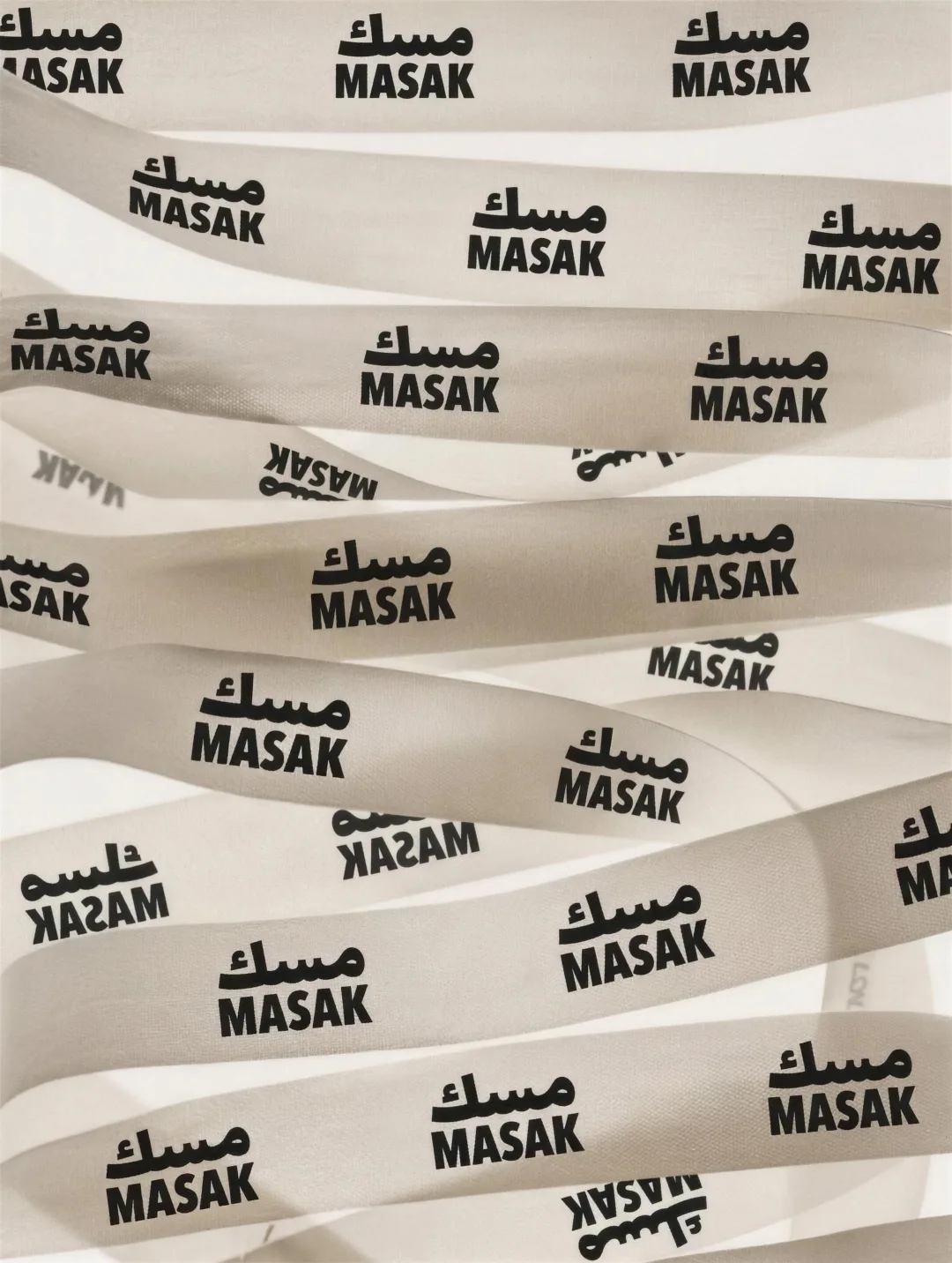 MASAK: the pale printed ribbons, the mark repeating across a metre of silk