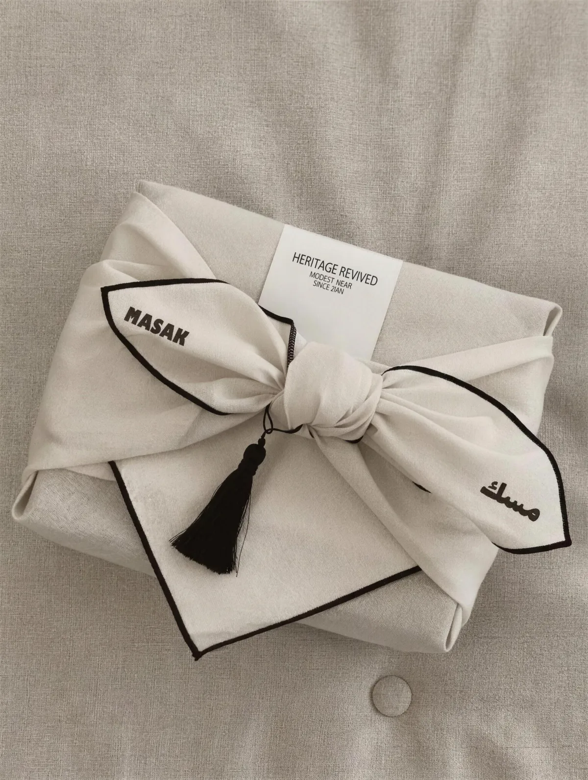 MASAK: the cloth-wrapped parcel finished with a knot and a black tassel