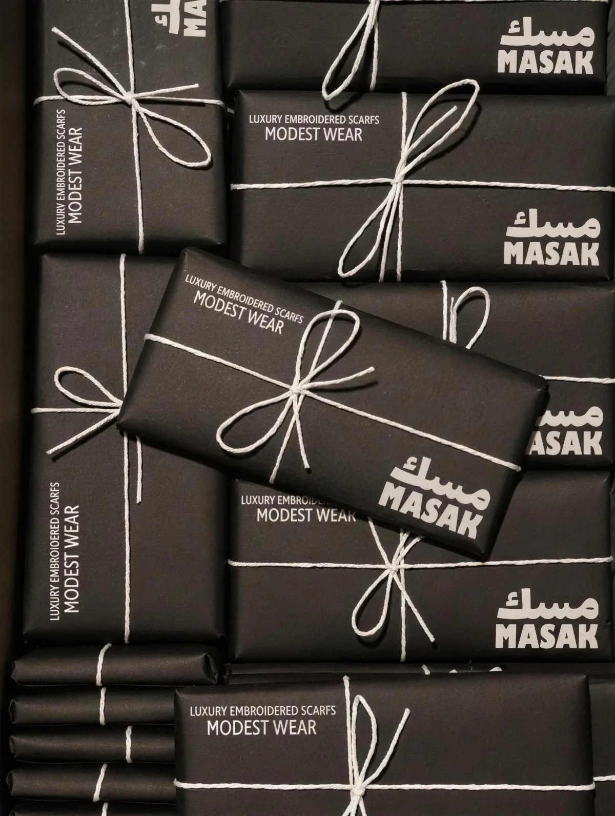 MASAK: the stack of black scarf parcels tied with white twine