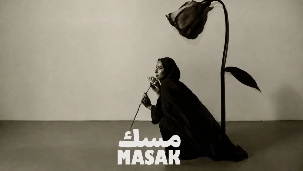 MASAK: the campaign portrait, a woman in an embroidered abaya holding a flower
