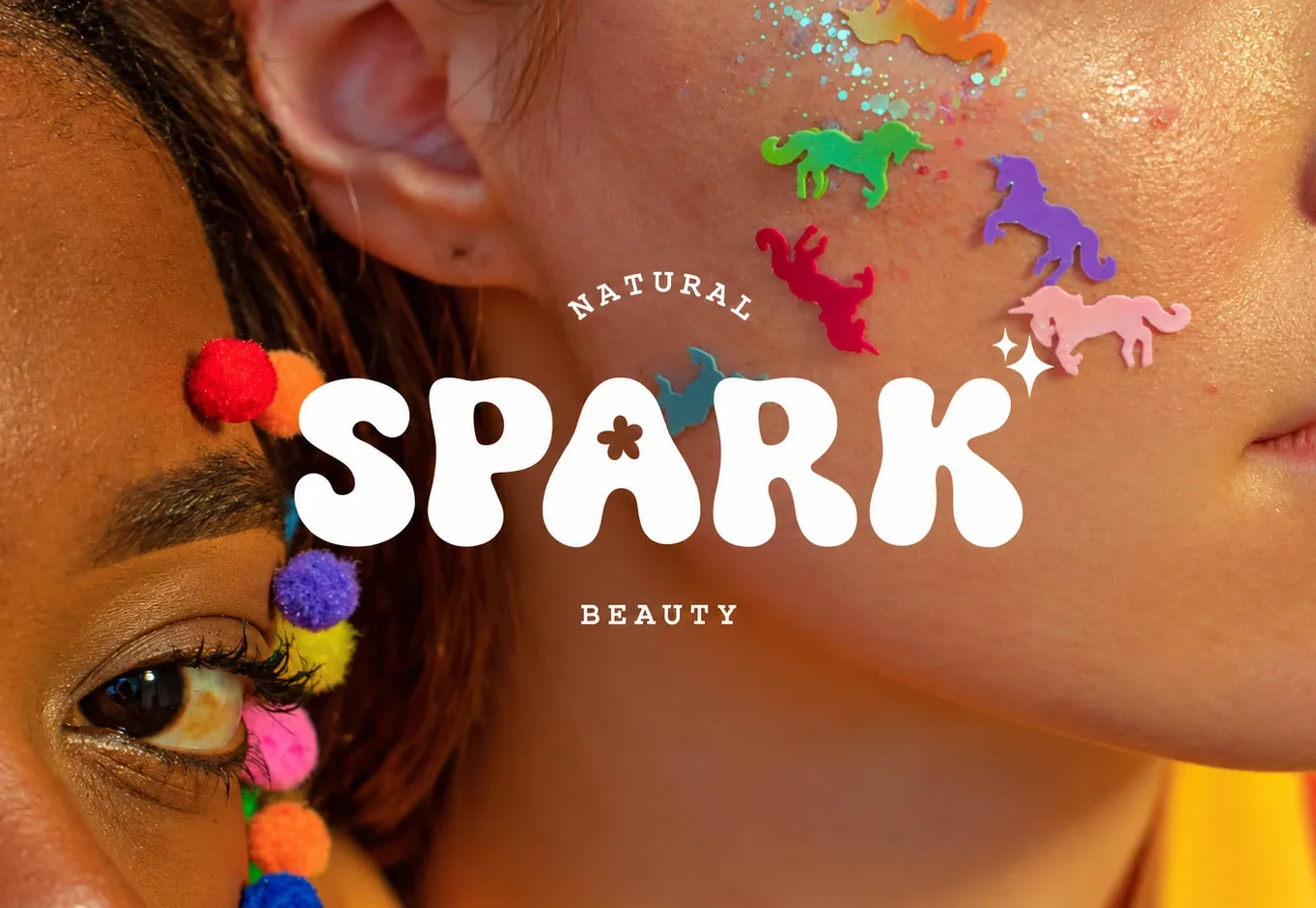 Spark Beauty: the SPARK wordmark over two faces with pom-poms and unicorn glitter