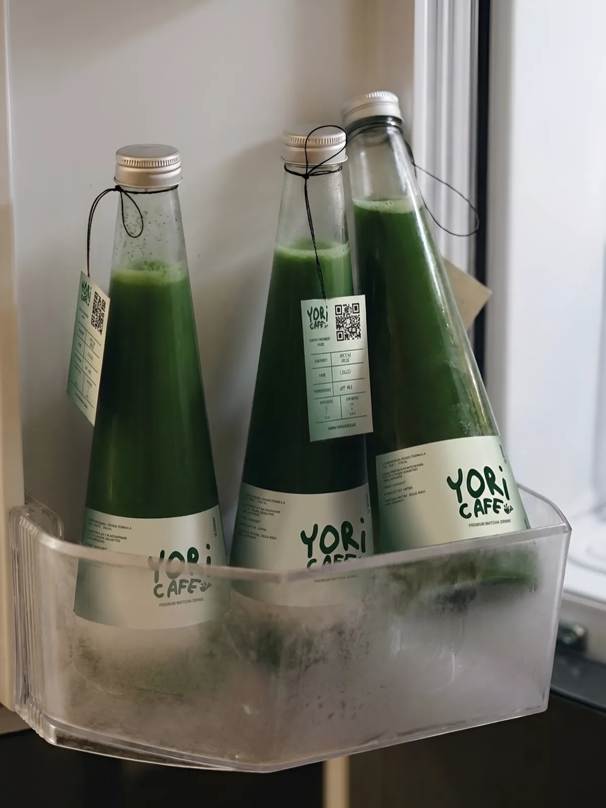 YORI CAFE: bottled matcha with YORI CAFE labels in a fridge door