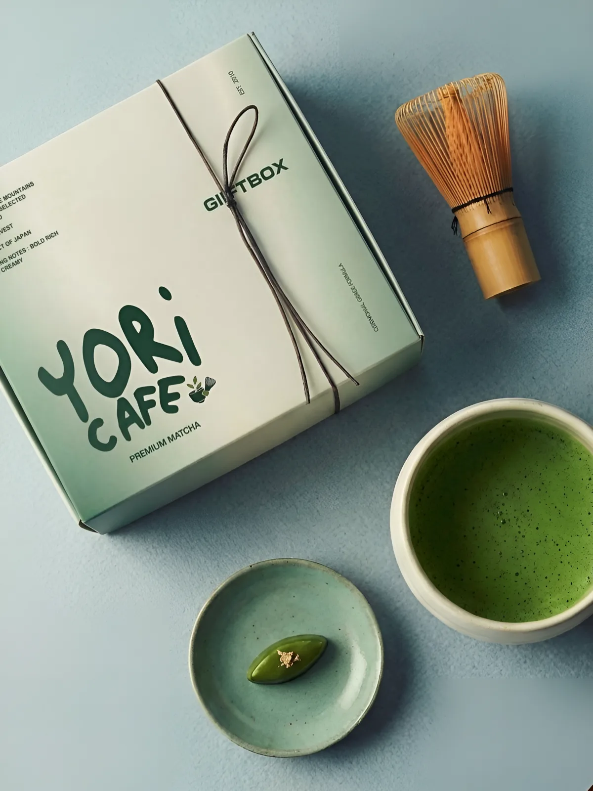 YORI CAFE: the YORI CAFE gift box beside a bamboo whisk and a bowl of matcha